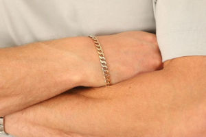 man wearing gold chain bracelet