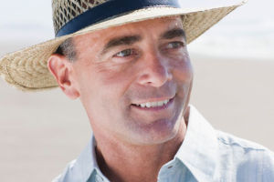 Man wearing straw surf hat