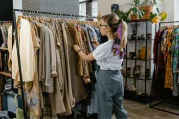 Woman browsing clothing rack in boutique