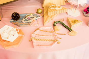 assorted jewelry styles on pink table