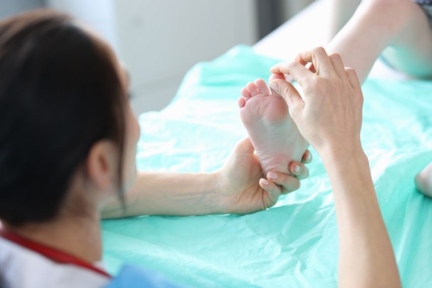 Podiatrist examining foot of small child