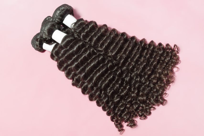 haire weave black hair extensions on pink background