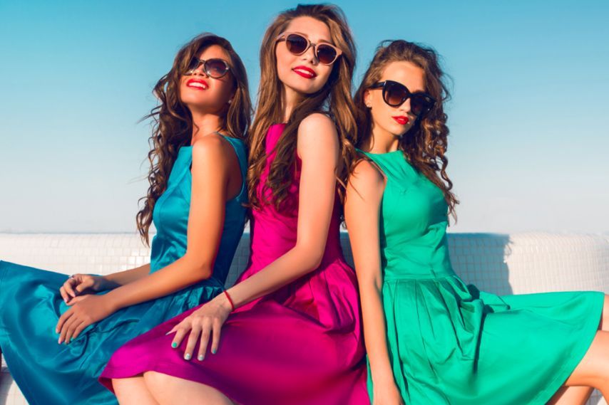 beautiful young girls in colorful summer dresses wearing sunglasses