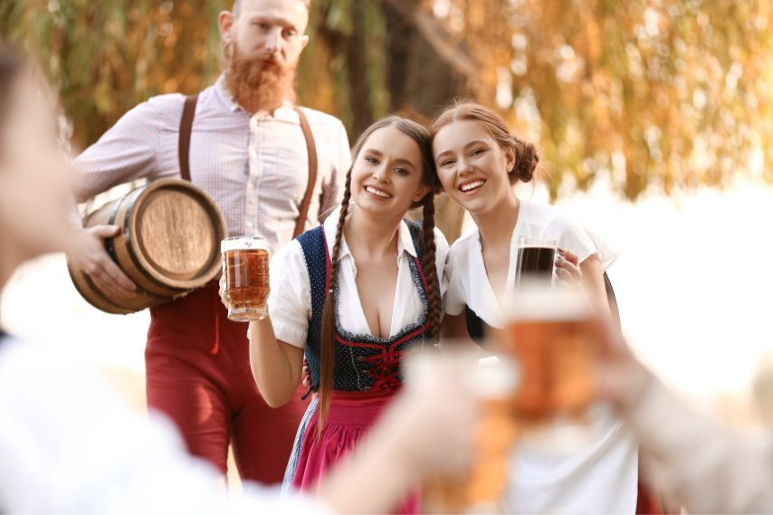 people celebrating octoberfest in traditional clothing