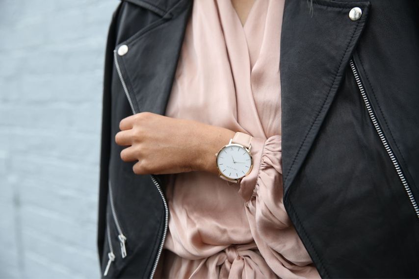 Woman wearing black leather jacket and watch