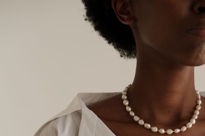 black woman earing pearls