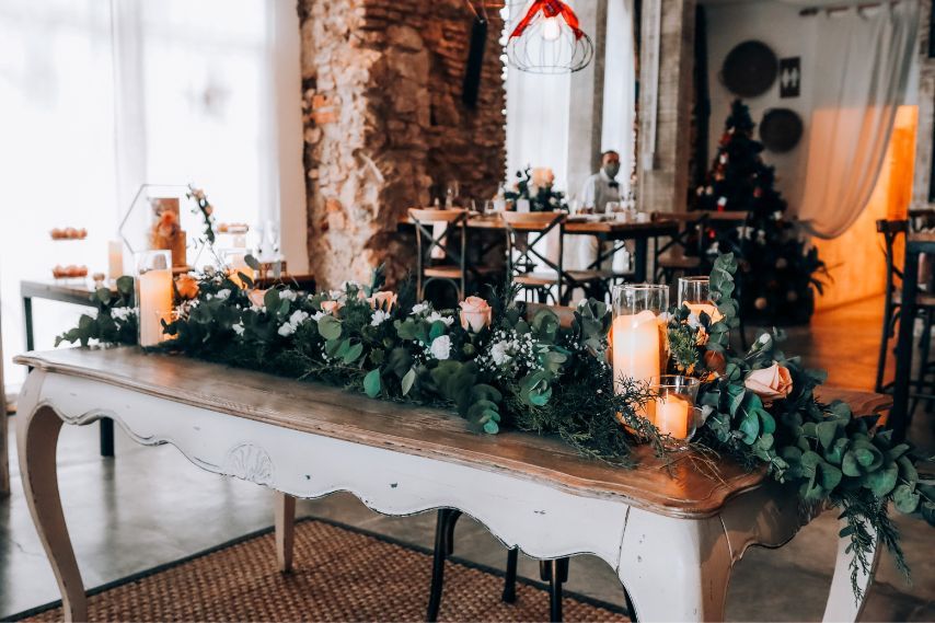 table decorated with flowers and candles for christmas
