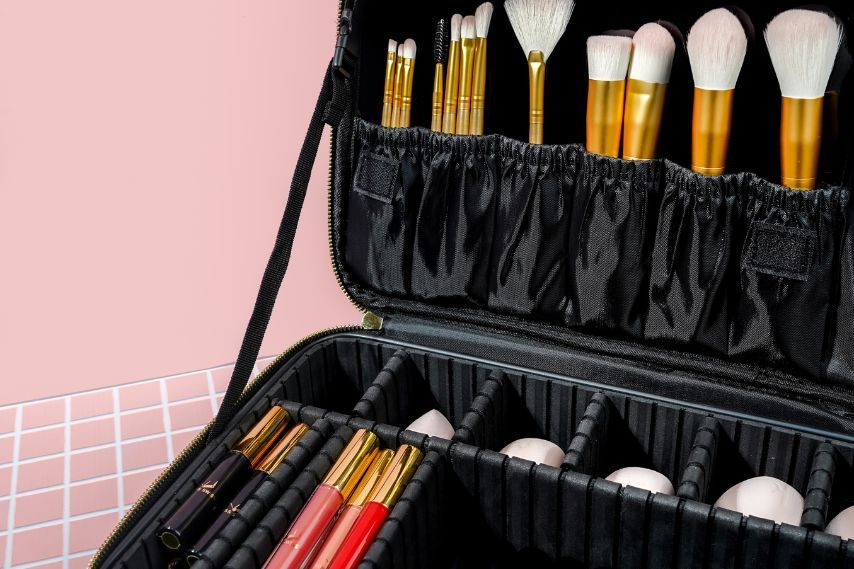 open hard case black cosmetic bag with brushes and makeup