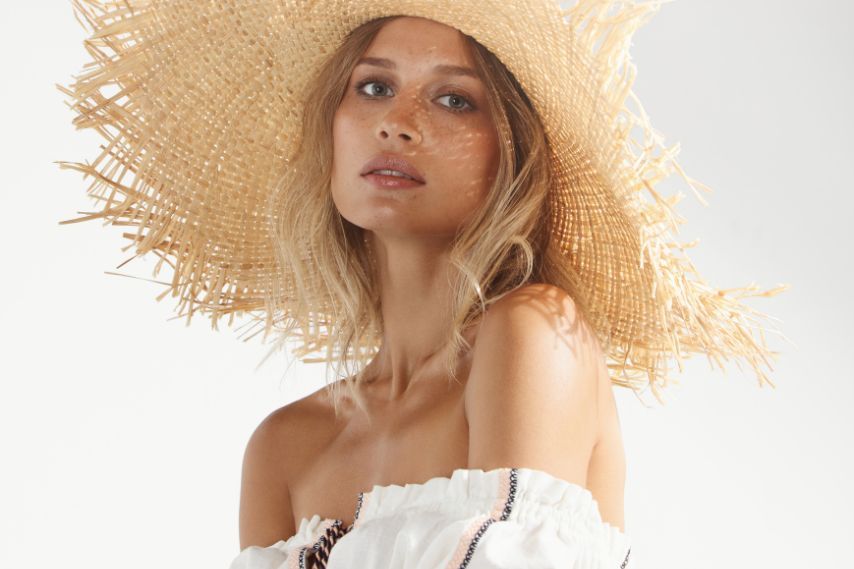 Beautiful woman wearing summer straw hat